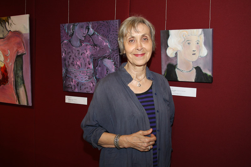 Dzidra Mitchell with her three paintings: from left, 