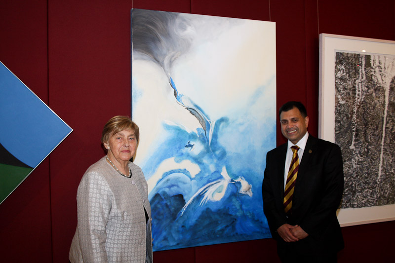 Biruta Clarke with her painting 