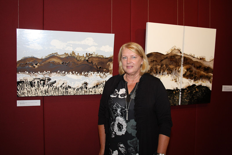 Alda Rudzis with her paintings 